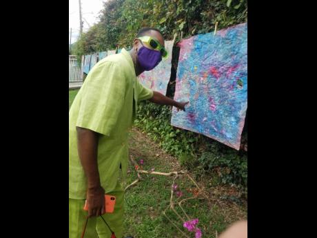 A patron reacting to one of Kwesi Abbensetts’ pieces.