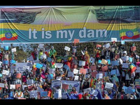 Ethiopians protest against international pressure on the government over the conflict in Tigray, below a banner referring to The Grand Ethiopian Renaissance Dam, at a demonstration organised by the city mayor’s office held at a stadium in the capital Add