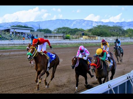 GENERATIONAL (left), ridden by Robert Halledeen, wins the seventh race, the  Millard Ziadie Memorial Trophy over 5-1/2  furlongs, at Caymanas Park yesterday. 