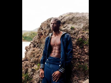 Emelio Stewart – seaside in Boston Bay, Portland – dons a sailor jacket with detachable pockets and sailor pants from House of Aama’s Salt Water collection.