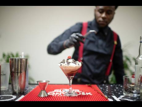 Bartender and mixologist Andrew Weir adds the final touches to his signature mix, whispering paradise. 