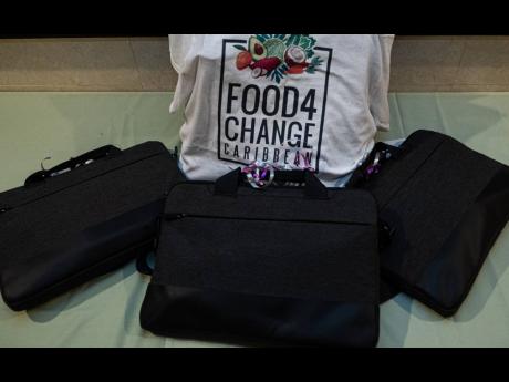Credit: Contributed Laptop computers that were presented to three Jamaican teenagers recently after winning the Food4Change Caribbean Story Writing Competition. The Jamaican winners are Mikaelia Nesbeth, Neville Anné Morgan and Haley Clarke.