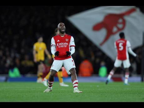 Arsenal’s captain Alexandre Lacazette celebrates after a late own goal handed his team a 2-1 win over Wolverhampton Wanderers in an English Premier League match at the Emirates Stadium in London yesterday. 