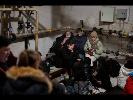 People take shelter in a building basement while the sirens sound announcing new attacks in the city of Kyiv, Ukraine yesterday.