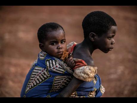 
People displaced by conflict wait for the arrival of United Nations Under-Secretary General for Peace Operations, Jean Pierre Lacroix, in Bunia, eastern Congo. 