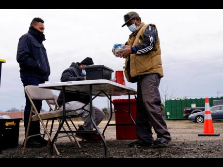 Credit: AP
Keith Lewis, right, picks up syringes from health educators Sterling Mitchell, centre, and Amir Gatlin-Colon at a needle exchange run by Camden Area Health Education Center in Camden, New Jersey, on Thursday, February 24.