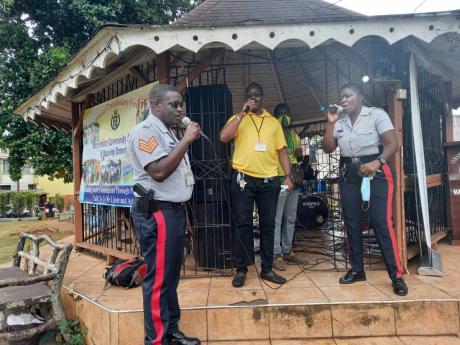 Members of the Community Safety  and Security Branch of the JCF at the Mandeville  Police Station during a performance with the Step by Step band.