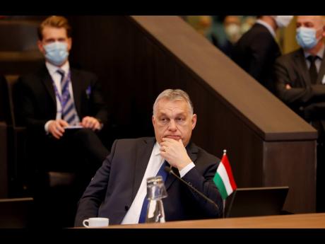 Hungarian Prime Minister Viktor Orban (foreground) attends a NATO leaders virtual summit at NATO headquarters in Brussels on February 25. Orban has nurtured close political and economic ties with Russia for more than a decade. But following Russia’s larg