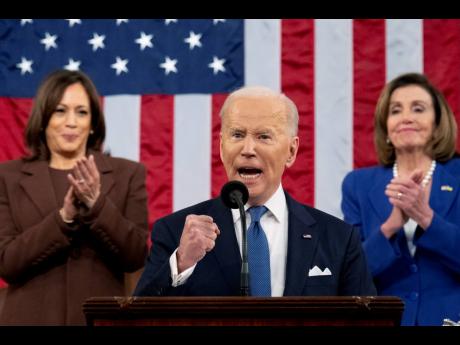 President Joe Biden delivers his first State of the Union address to a joint session of Congress at the Capitol, as Vice President Kamala Harris and House Speaker Nancy Pelosi watch on Tuesday in Washington.