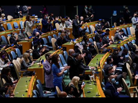 United Nations members stand up and applaud after a vote on a resolution concerning Ukraine during an emergency meeting of the General Assembly at United Nations headquarters on Wednesday.