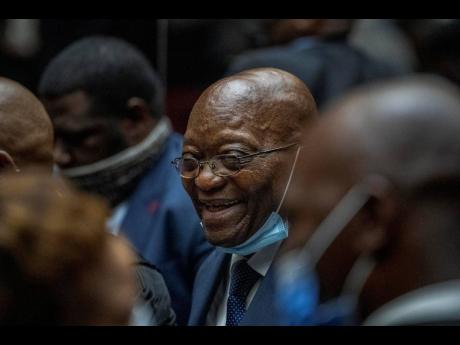 Former South African President Jacob Zuma consults with his legal team during a recess at the High Court in Pietermaritzburg, South Africa, on January 31. The court has dismissed Zuma’s attempt to remove the prosecutor from his upcoming corruption trial.
