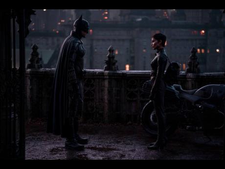 Robert Pattinson (left), and Zoe Kravitz in a scene from ‘The Batman’.