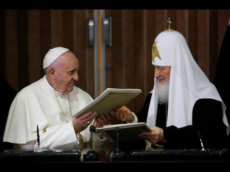 AP 
Pope Francis (left) and Russian Orthodox Patriarch Kirill exchange a joint declaration on religious unity in Havana, Cuba, on February 12, 2016. The head of the Polish bishops’ conference had done what Pope Francis has so far avoided doing by publicl