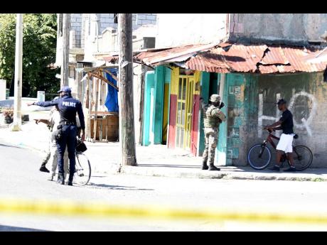 Police officers along with crime scene detectives at a section of North Street at the intersection of Regent Street after a shooting incident.