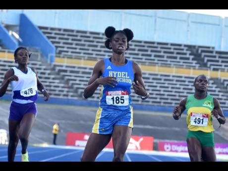Daena Dyer (centre) of Hydel High School wins the under 20 400m dash at the Carifta Trials on Saturday, March 12, 2022 at the National Stadium.