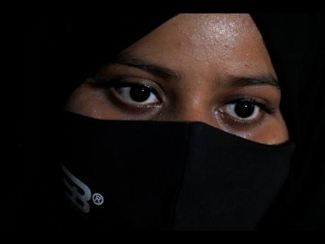 Ayesha Imtiaz, an Indian Muslim student barred from school for wearing hijab, sits for an interview with the Associated Press at a cafe in Udupi, Karnataka state, India, on February 24.