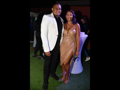 Floyd Green (left), minister without portfolio in the Office of the Prime Minister, and his fiancée, Dr Kerida Bryce, who stunned in a plunging tan bodycon dress. 