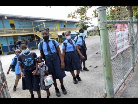 Students leaving Constitution Hill Primary School in St Andrew East Rural on Monday.