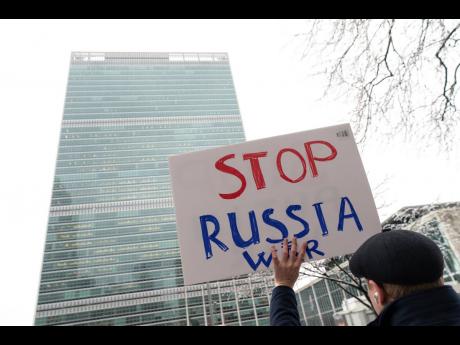 
A protester against the Russia-Ukraine war holds a sign outside United Nations headquarters on February 25 in New York. 