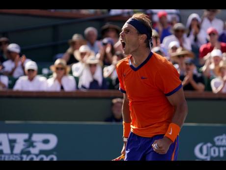 Rafael Nadal, of Spain, celebrates winning a game over Reilly Opelka at the BNP Paribas Open tennis tournament Wednesday, March 16, 2022, in Indian Wells, California.