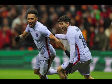 Barcelona’s Pierre-Emerick Aubameyang (left) celebrates with teammate Pedri after scoring his side’s second goal during the Europa League round of 16 second leg  match between Galatasaray and Barcelona in Istanbul, Turkey yesterday.