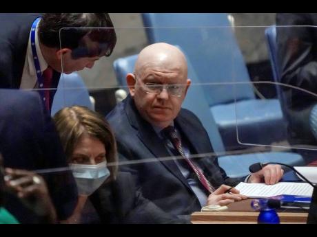 Russian Ambassador Vassily Nebenzia (right) confers during a meeting of the United Nations Security Council on the humanitarian crisis in Ukraine, Thursday March 17, 2022 at UN Headquarters.