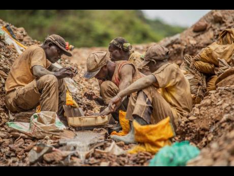 Gold miners pan for gold in the Eastern Congo mining town of Kamituga in March 2021. The US announced sanctions Thursday, March 17, targeting Alain Goetz and African Gold Refinery, a Uganda-based company that has been in business since 2014. 