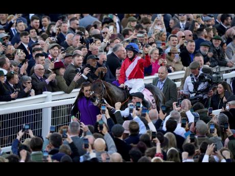 A Plus Tard, ridden by Rachael Blackmore, after winning the Boodles Cheltenham Gold Cup Chase during day four of the Cheltenham Festival at Cheltenham Racecourse, England yesterday. 
