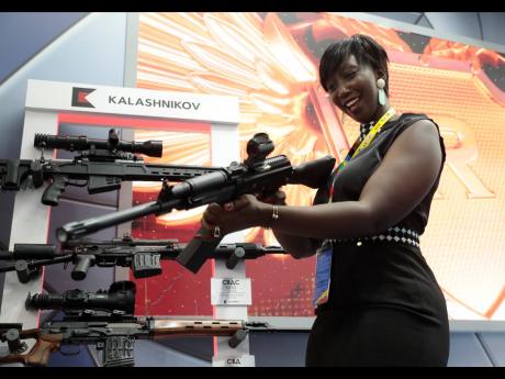 A visitor handles a gun at an exhibition by the Kalashnikov company on the sidelines of the Russia-Africa summit in the Black Sea resort of Sochi, Russia, in 2019. Amid a worldwide chorus of condemnation against Russia’s war on Ukraine, Africa has remain