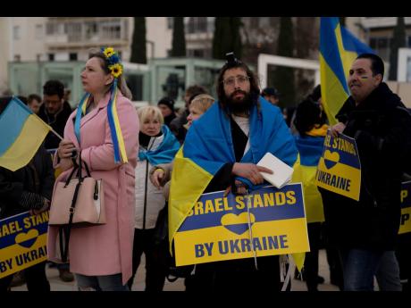 People gather in Habima Square in Tel Aviv, Israel, to watch Ukrainian President Volodymyr Zelenskyy in a video address to the Knesset, Israel’s parliament, yesterday.