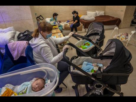 Nannies take care of newborn babies in a basement converted into a nursery in Kyiv, Ukraine.