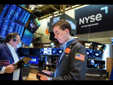 Traders working on the floor of the NYSE on Monday, March 21. AP