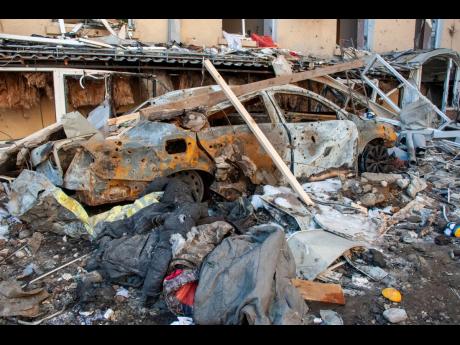 A car destroyed by shelling is seen in a street in Kharkiv, Ukraine, yesterday.