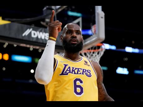 Los Angeles Lakers’ LeBron James celebrates his basket against the Toronto Raptors during the first half of an NBA basketball game on Monday, March 14, in Los Angeles. 