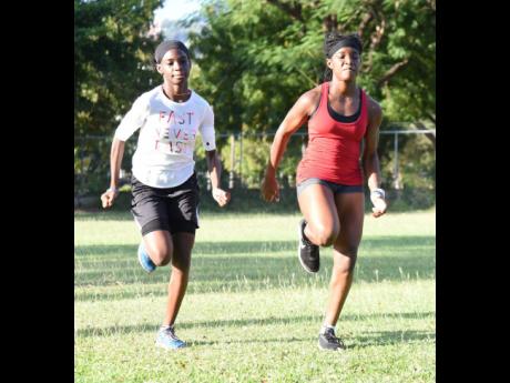 Kedoya Lindo (left) and Kyra-Loye Kelly during sprint training at  Immaculate Conception High School on Friday, March 18.