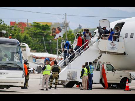 Haitians who were deported from the United States deplane at the Toussaint Louverture International Airport, in Port-au-Prince, Haiti, on September 19. 