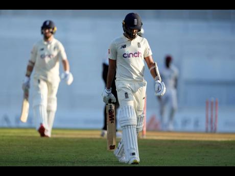 England’s Saqib Mahmood leaves the field after being bowled by West Indies’ Jermaine Blackwood in the last over of day one of the third Test match at the National Cricket Stadium in St George’s, Grenada yesterday.