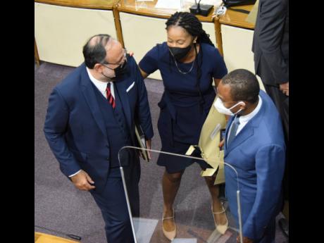 Opposition Leader Mark Golding (left) is congratulated by Rhoda Crawford (centre), government member of parliament for Manchester Central, and Dr Nigel Clarke, the finance minister, shortly after making his contribution to the 2022-2023 Budget Debate in th