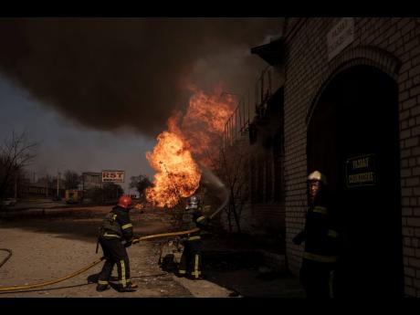 Firefighters battle a fire following a Russian attack in Kharkiv, Ukraine, yesterday.