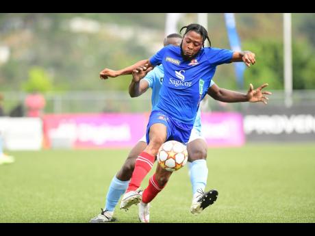 Deanandre Thomas (foreground) of Dunbeholden FC dribbles away from Elvis Wilson of Waterhouse FC  during a Jamaica Premier League match at the UWI-JFF Captain Horace Burrell Centre of Excellence in St Andrew on Sunday, January 30, 2022. 