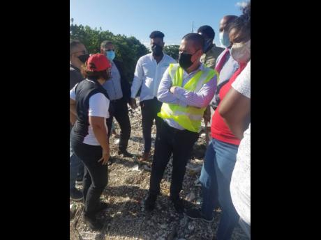 Credit: Paul H Williams CEO of Grace Kennedy Foundation Caroline Mahfood makes a point at a stop on the tour of gullies near Rae Town Fishing Village in Kingston. Among those present are Minister without Portfolio in the Ministry of Growth and Job Creation, Matthew Samuda (in gre