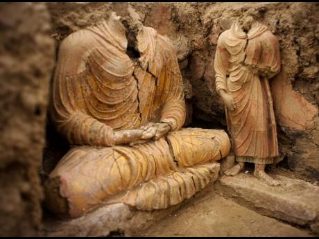 In this October 2010 photograph, Buddha statues are seen inside an ancient temple in Mes Aynak valley, south of Kabul, Afghanistan. The valley is the world’s second-largest unexploited copper reserve, estimated to be worth nearly $1 trillion.