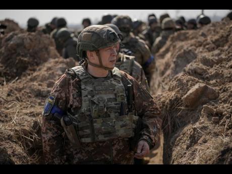 Col Gen Oleksandr Syrskyi, top military commander in charge of the defence of the Ukrainian capital, walks in a trench at a position north of the capital Kyiv, Ukraine, yesterday. The first face-to-face talks in two weeks between Russia and Ukraine began T
