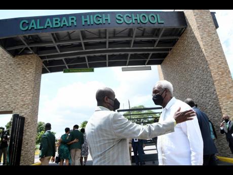 P.J Patterson (right), former prime minister, has a conversation with the Rev Karl Johnson, chairman of the Calabar High board, at a ceremony dedicating the Red Hills Road school’s new state-of-the-art gateway in honour of celebrated alumni Patterson and