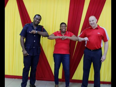 From left: Marlon Buchanan, assistant superintendent, officer operations, Jamaica Fire Brigade; Tamara Dunbar, training and development manager, ATL Automotive; and Mike Bebbington, ATL Automotive’s technical training manager, celebrate the completion of