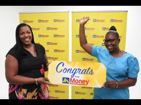 Sanya Wallace (left), senior manager, strategic planning and marketing at JN Money, celebrates with Khadean Young, community health aide, as she is presented with $25,000 on her JN Money card recently, as part of JN Money’s Cashmus Christmas promotion.
I