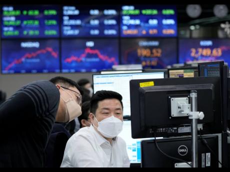 
Currency traders watch monitors at the foreign exchange dealing room of the KEB Hana Bank headquarters in Seoul, South Korea, on Thursday, March 31. 