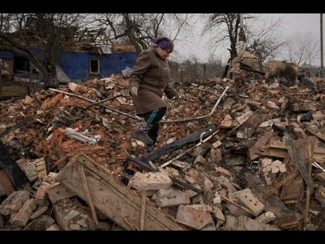 Mariya, a local resident, looks for personal items in the rubble of her house, destroyed during fighting between Russian and Ukrainian forces in the village of Yasnohorodka, on the outskirts of Kyiv, Ukraine, Wednesday.