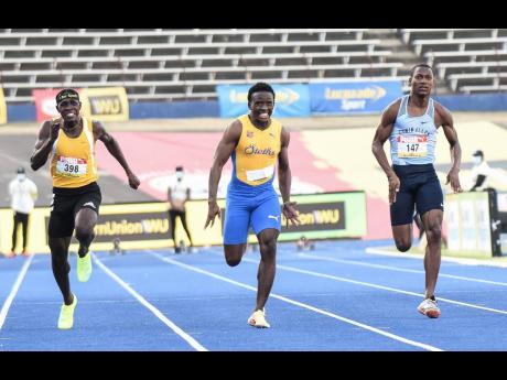Credit: Ian Allen/Photographer Sachin Dennis (centre) of St Elizabeth Technical High powers to victory in the Class One boys’ 100m in 10.53 seconds at last year’s ISSA/GraceKennedy Boys and Girls’ Athletic Championship. Antonio Watson (left) of Petersfield High claimed second in 1