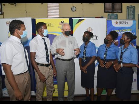 Credit: Ashley Anguin Justice Minister, Delroy Chuck in conversation with students (left) Kishon Maddipati, Miltahnu Thompson, Serina Malcolm, Petrina Scott and Asharnie Robinson at the Manning’s School in Westmoreland yesterday, as part of his parish tour to promote the Alte